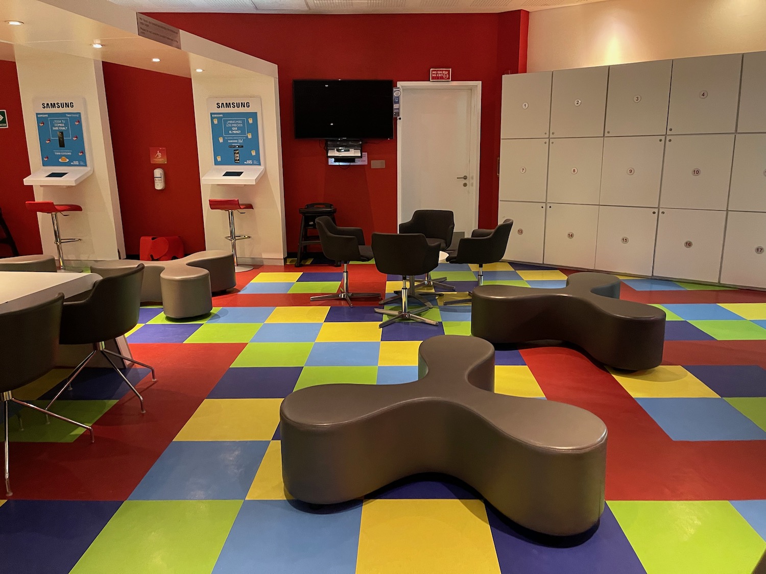 a room with colorful flooring and chairs