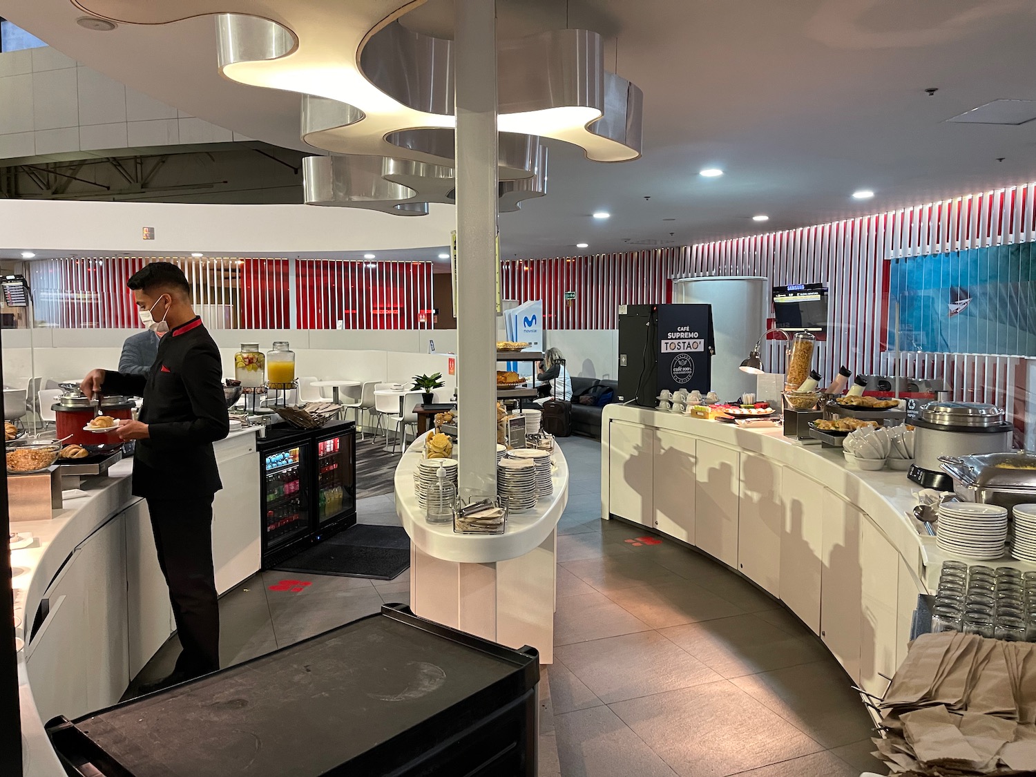 a man standing at a counter in a restaurant