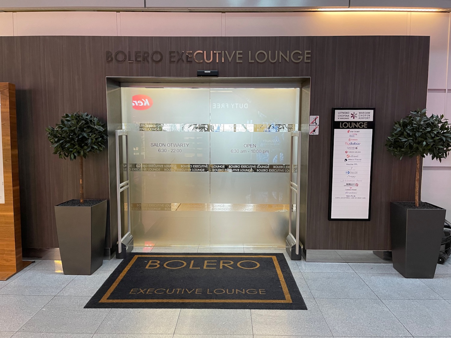 a glass door with a sign in front of a lounge