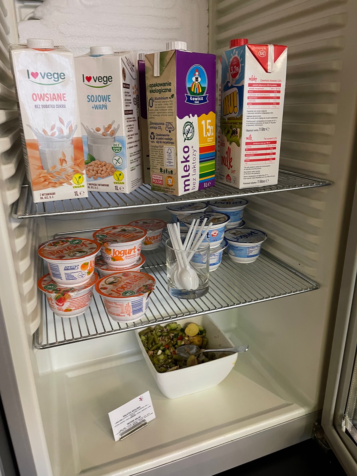 a refrigerator with food on shelves