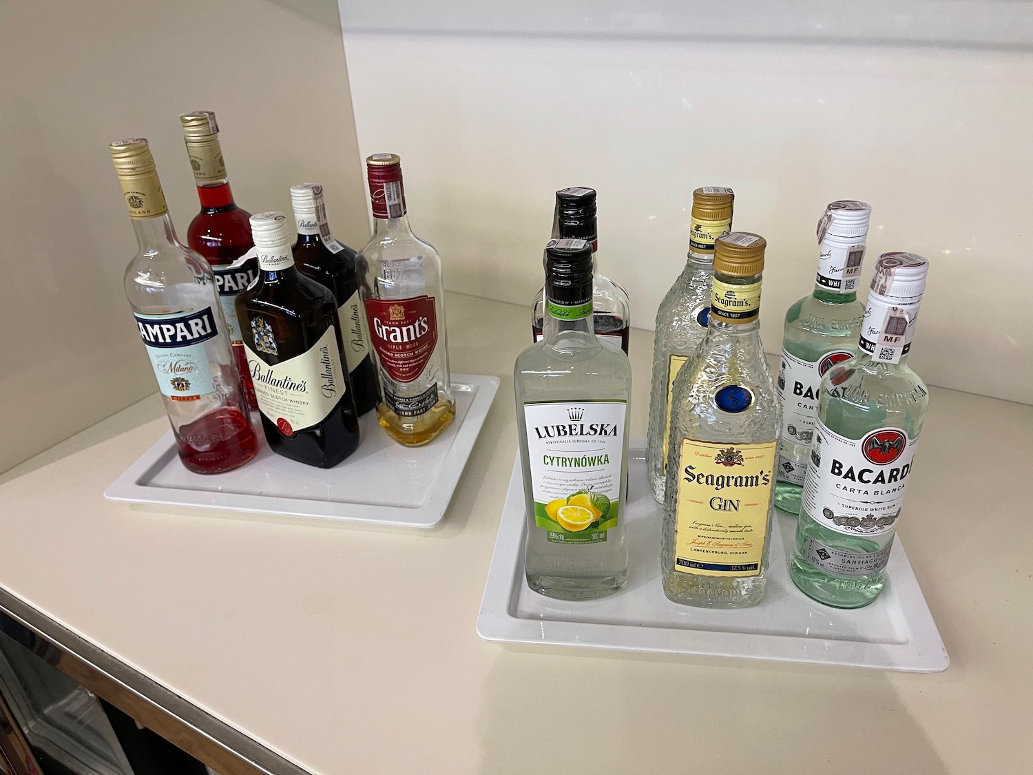 a group of bottles of alcohol on a white counter