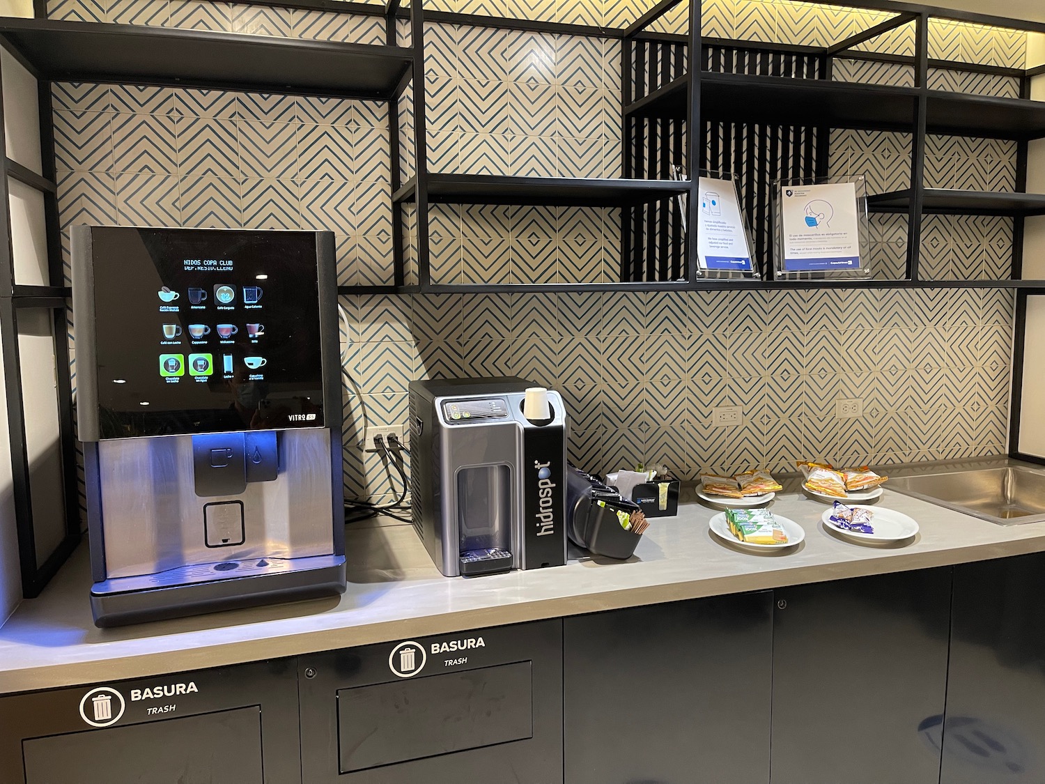 a coffee machine and plates of food on a counter