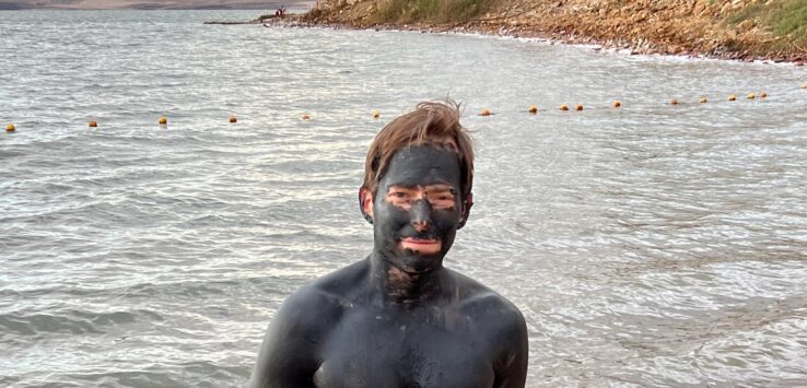 a man with black face and body of water