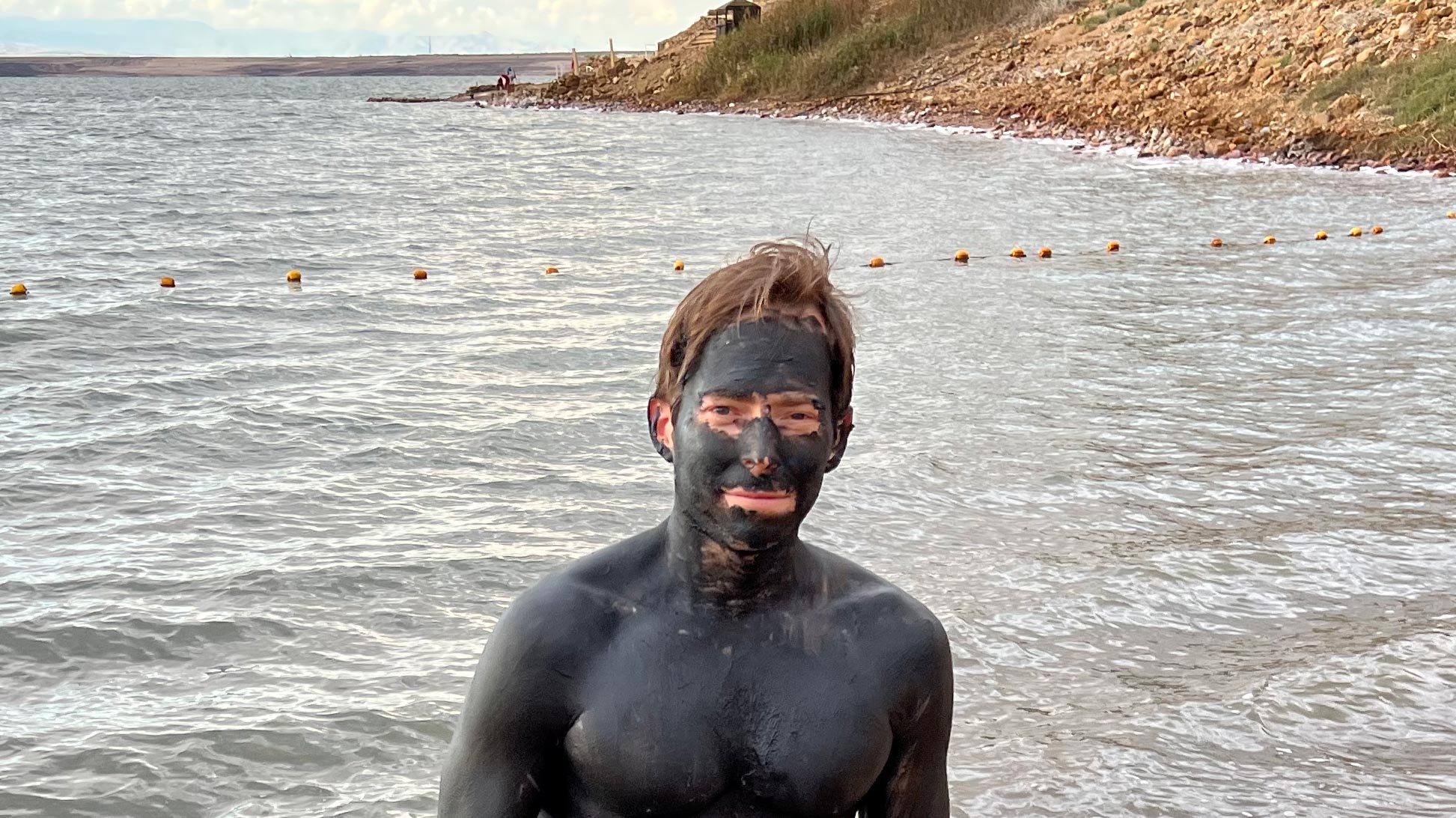 a man with black face and body of water