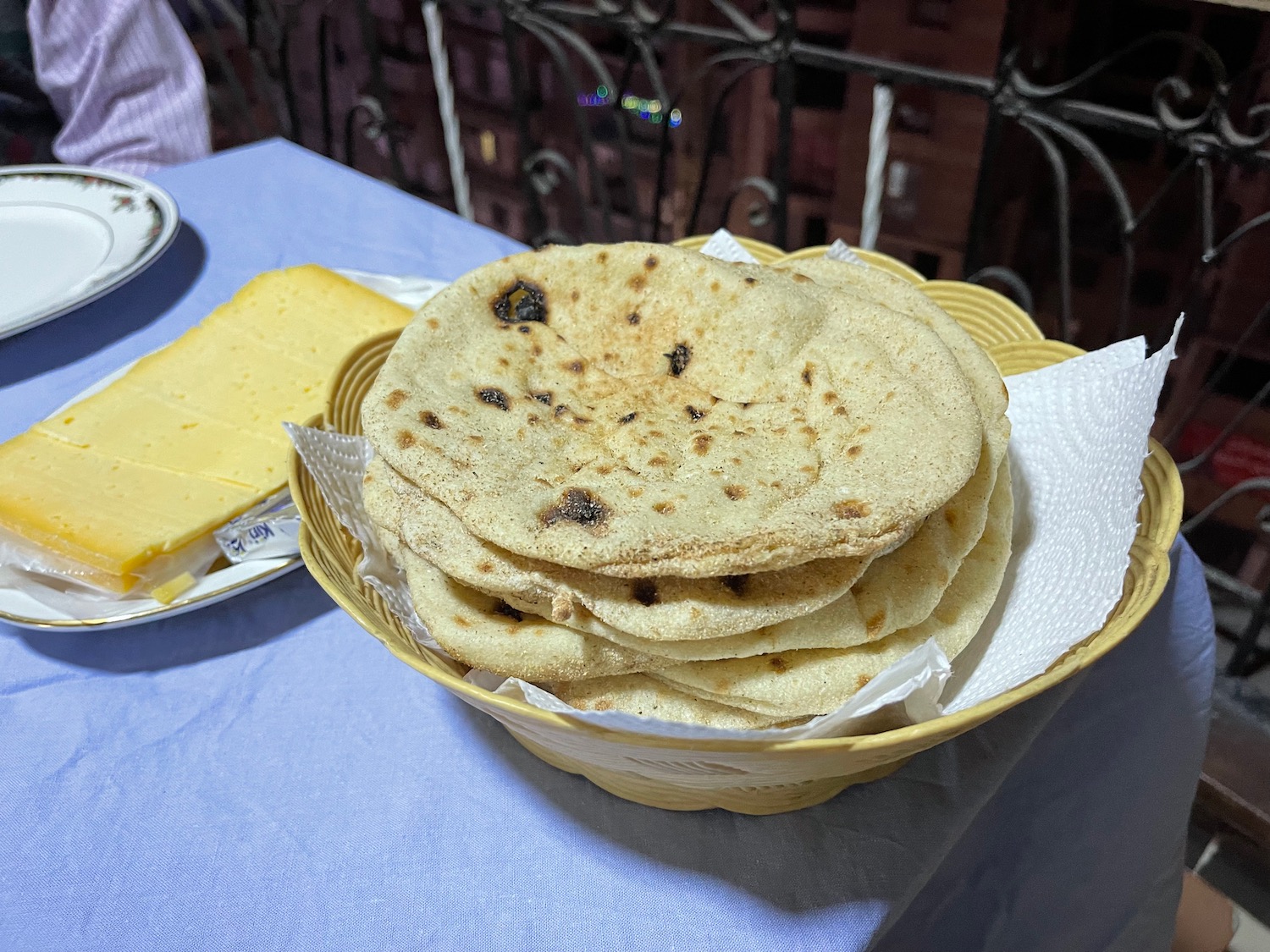 a basket of flat bread and cheese