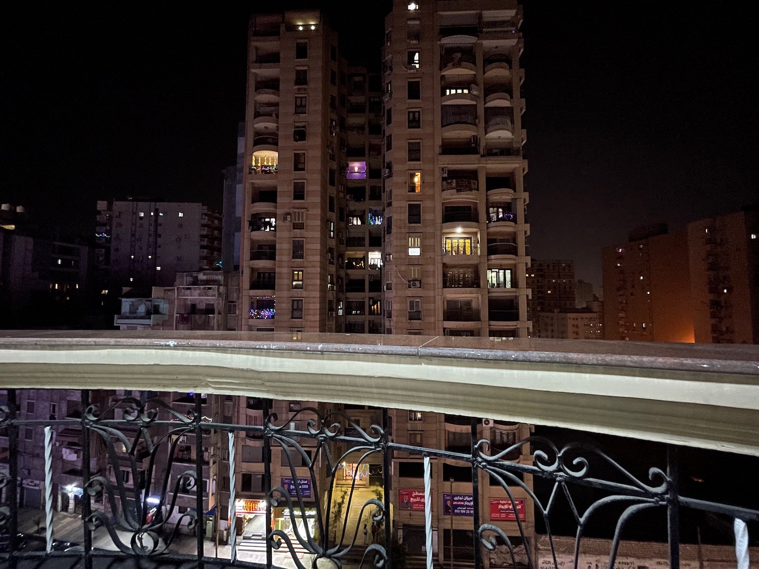 a balcony with a building in the background