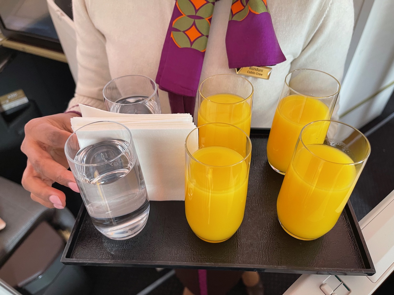 a tray of glasses and glasses of orange juice
