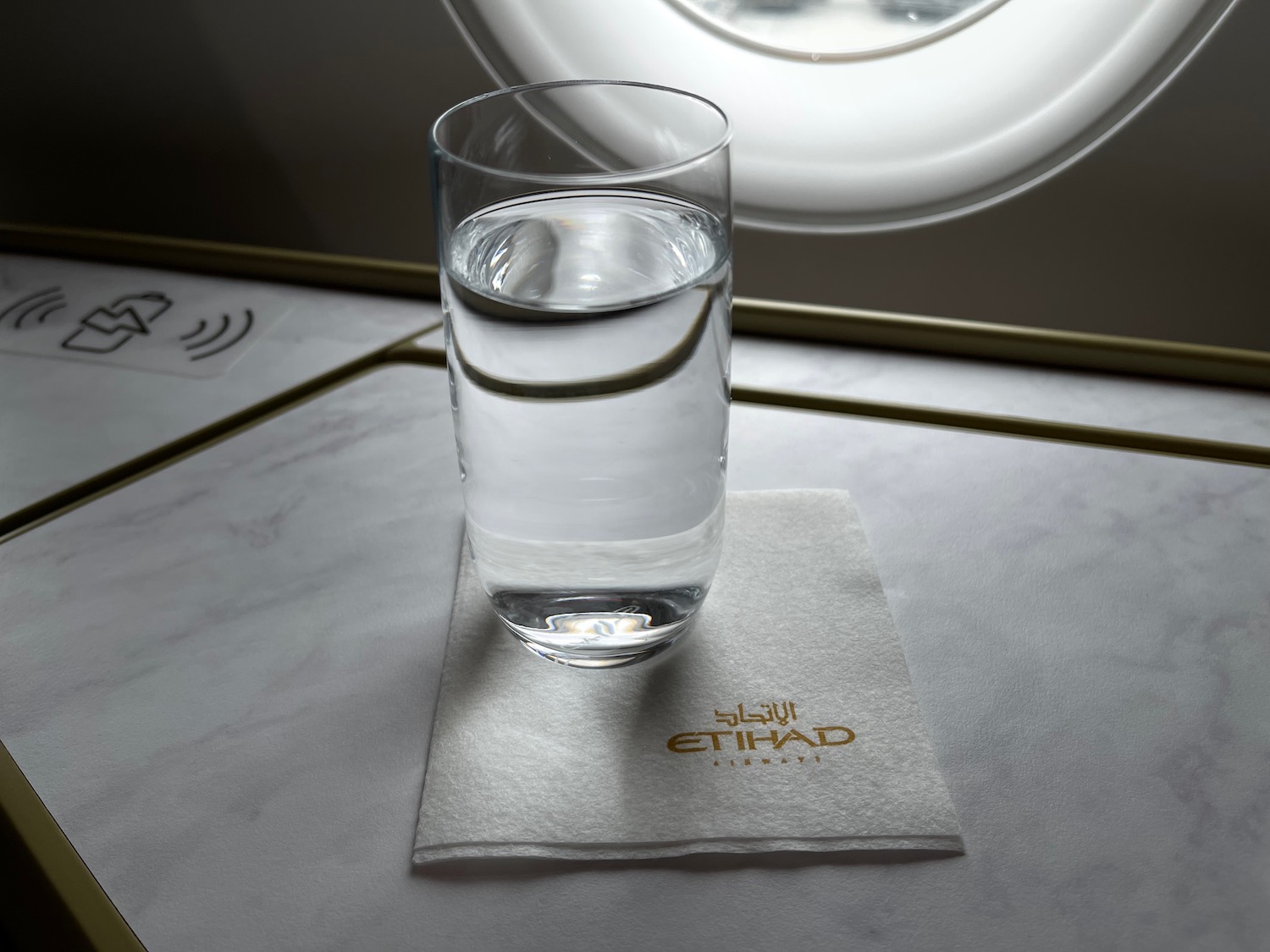 a glass of water on a napkin