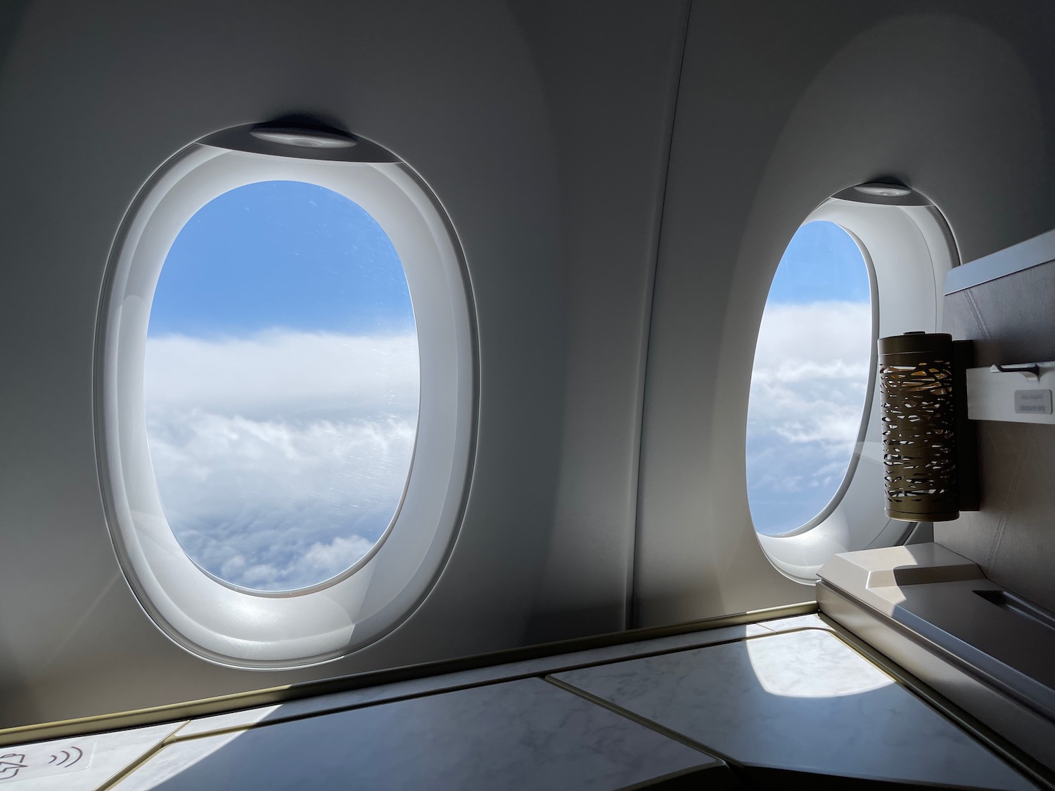 a window with oval windows and a blue sky