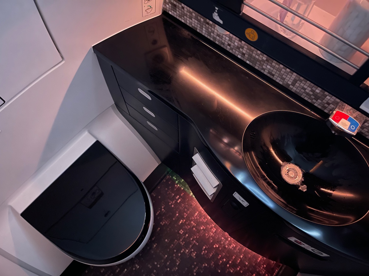 a black sink and toilet in a bathroom