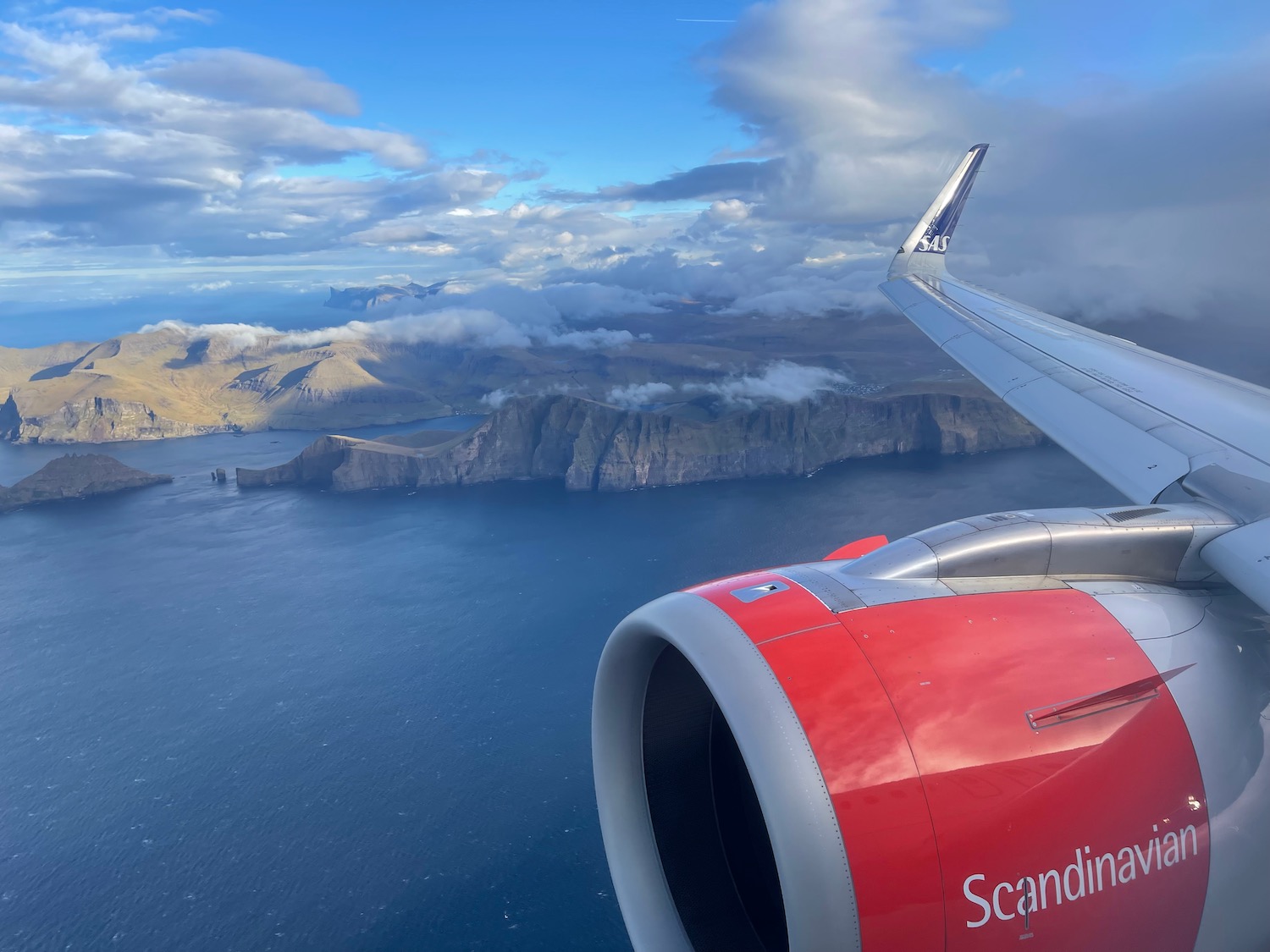 an airplane wing and engine above water