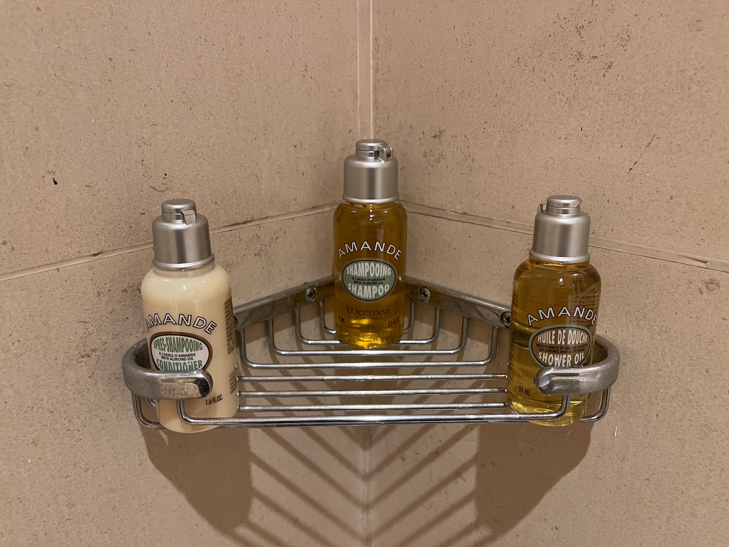 a group of bottles of shampoo on a metal shelf