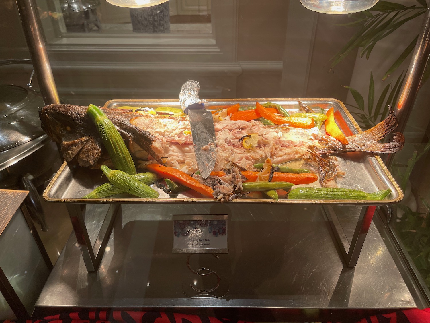a tray of food with fish and vegetables on it