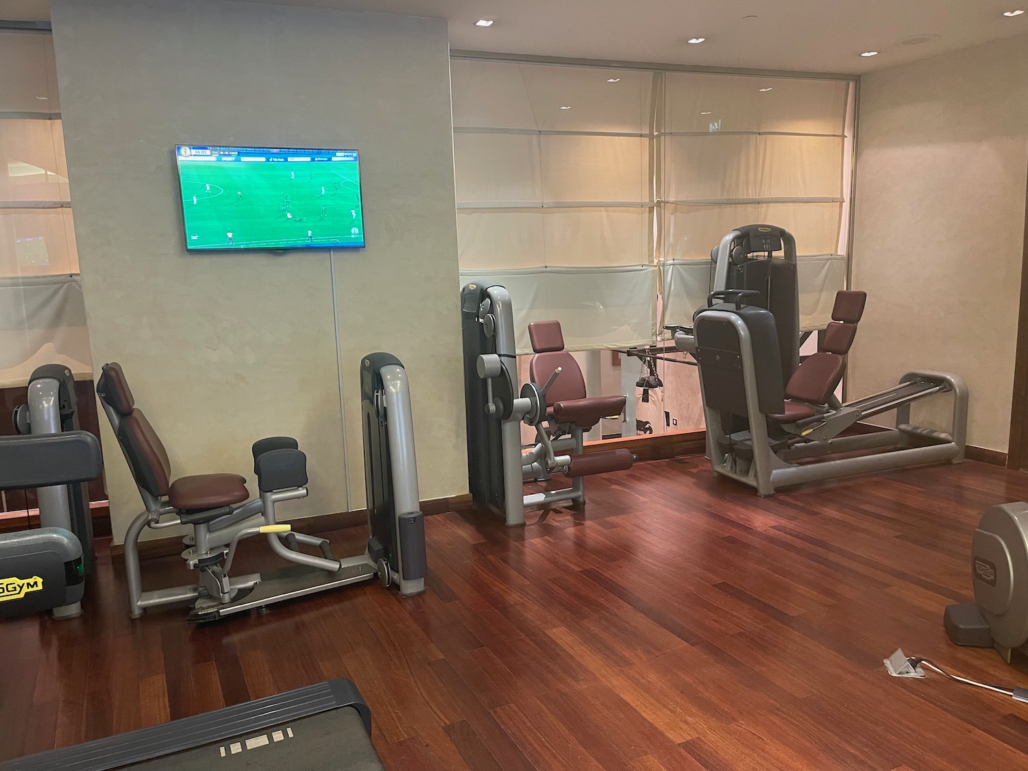 a room with exercise equipment and a television