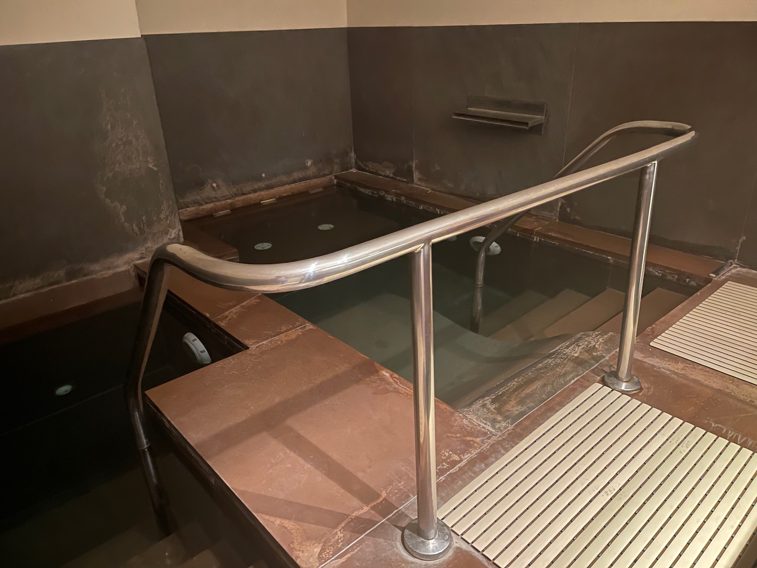 a hot tub with a metal railing