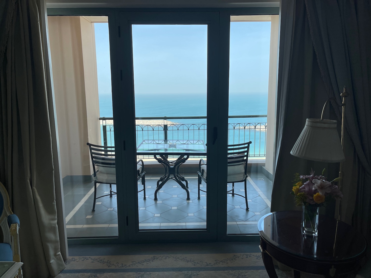 a glass doors with a view of the ocean