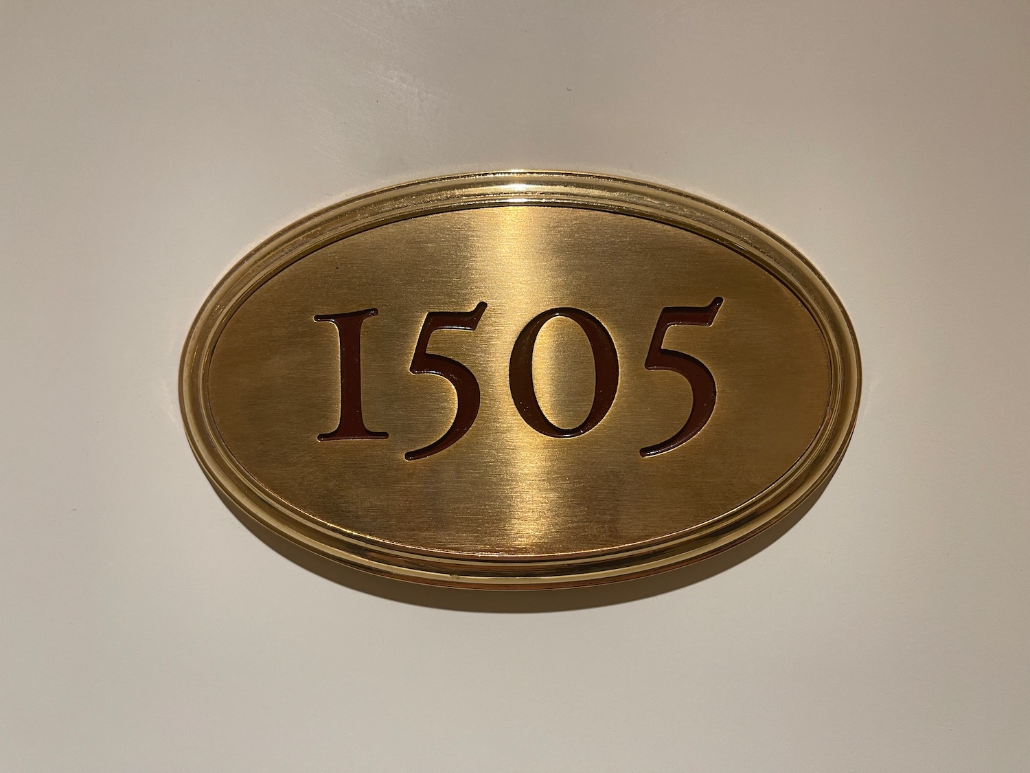 a gold oval sign with numbers on it