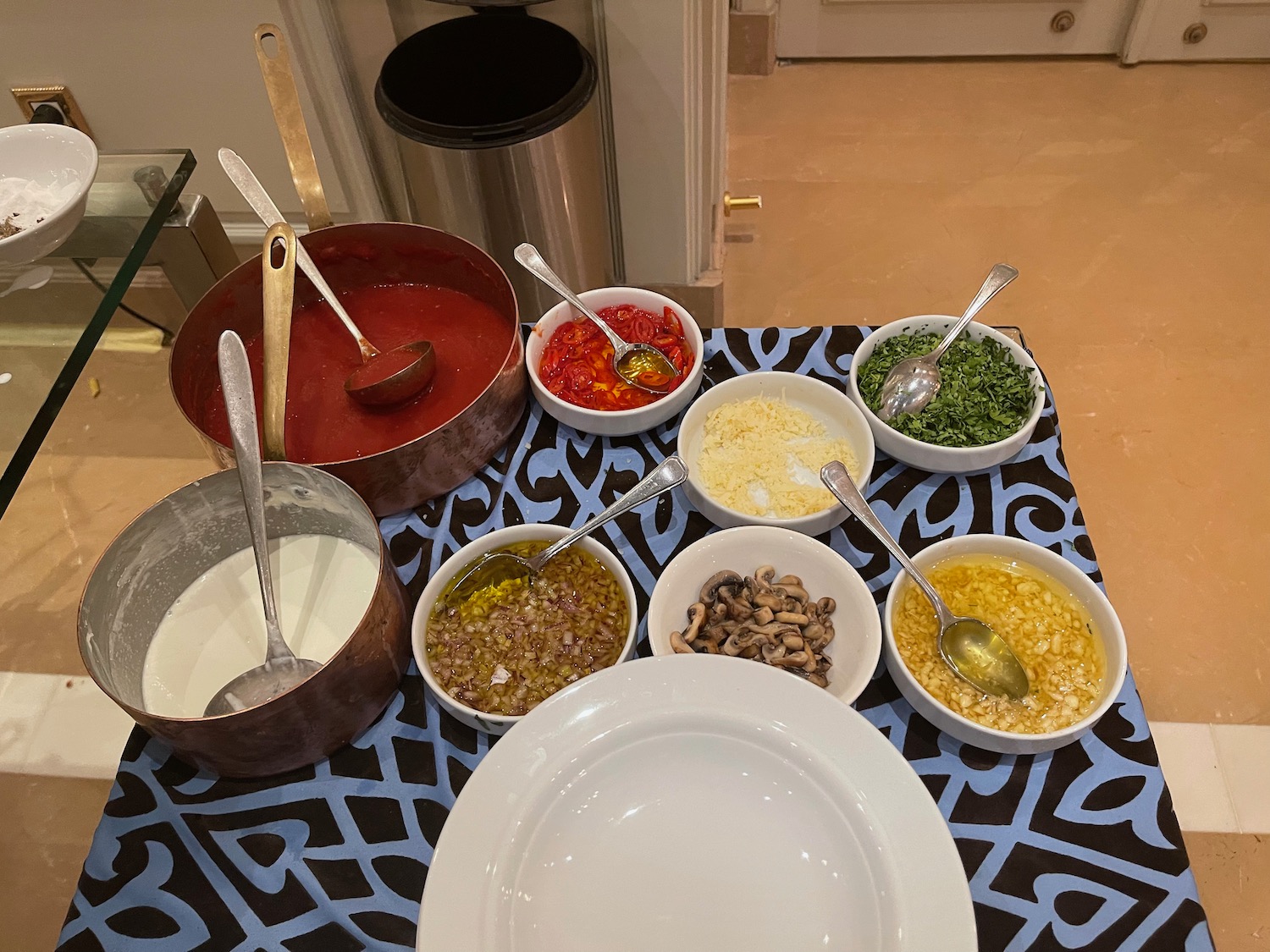 a table with bowls of food and spoons