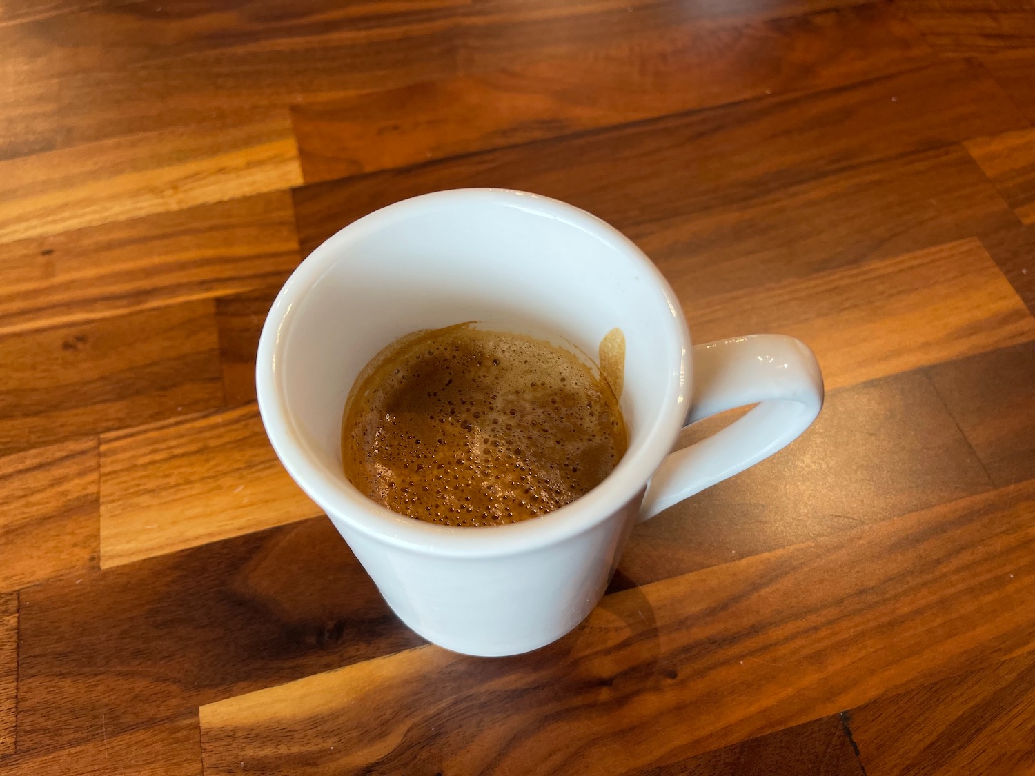 a cup of coffee on a wood surface