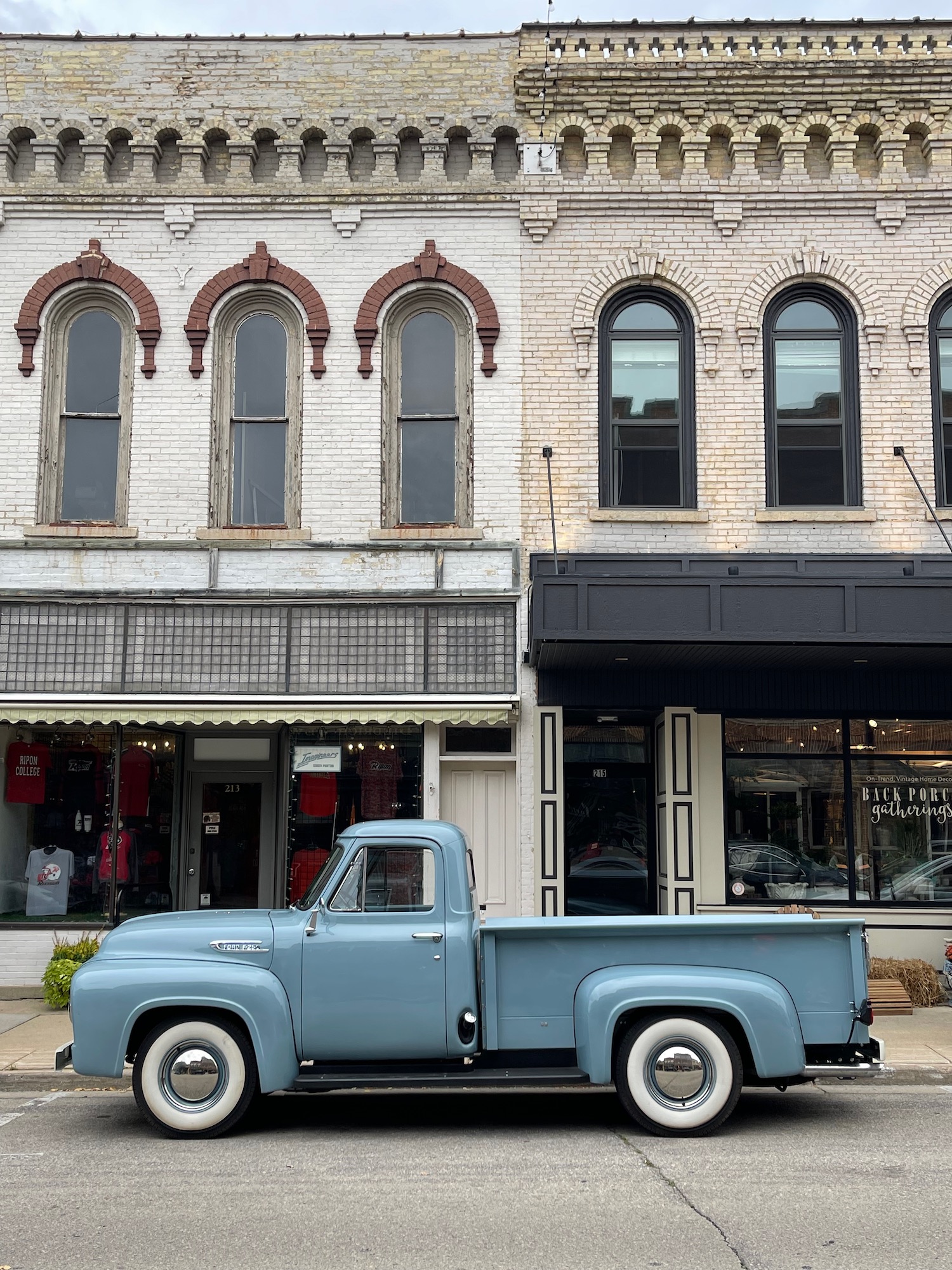 a blue truck parked on the side of a street