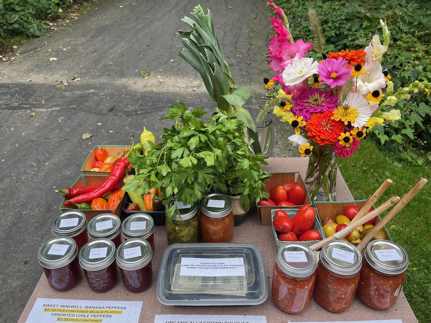 a table with jars of food and flowers