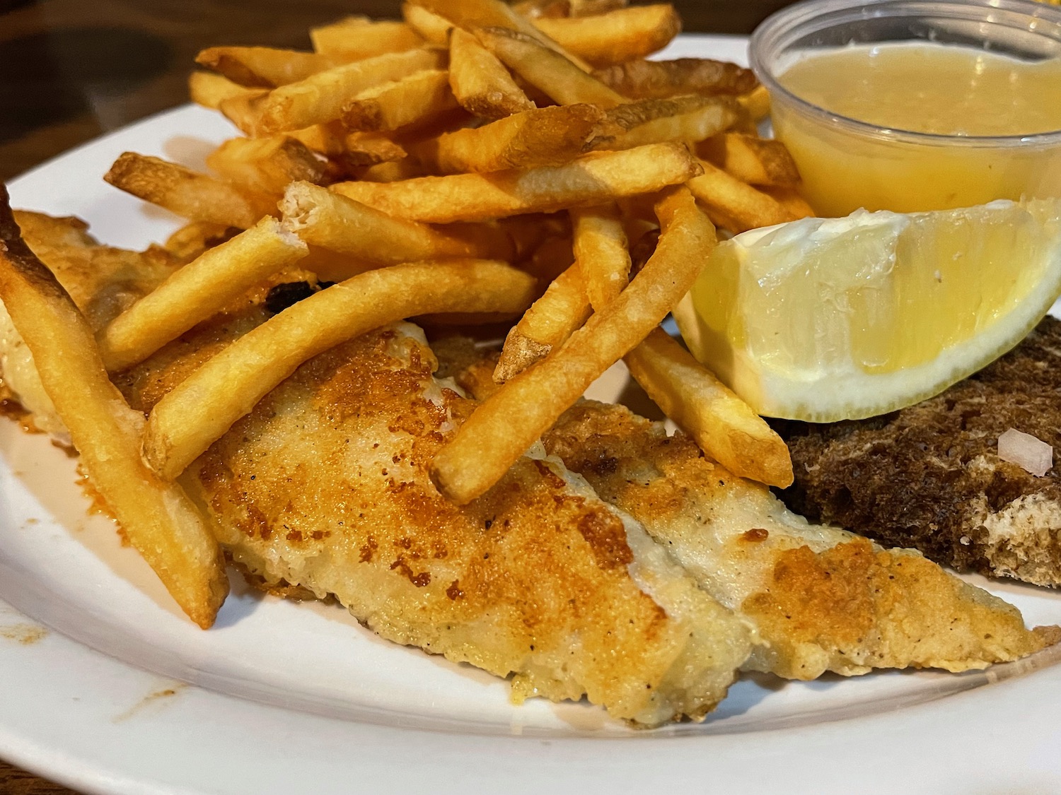 a plate of food with a side of fries and sauce