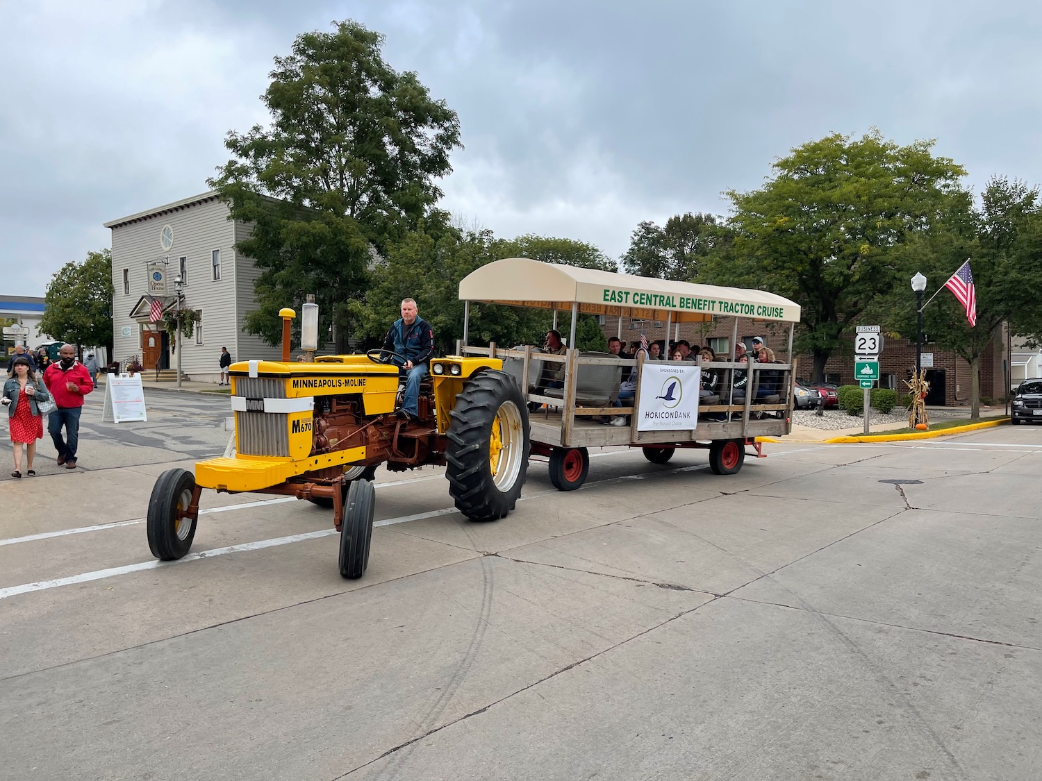 a tractor pulling a cart with people on it