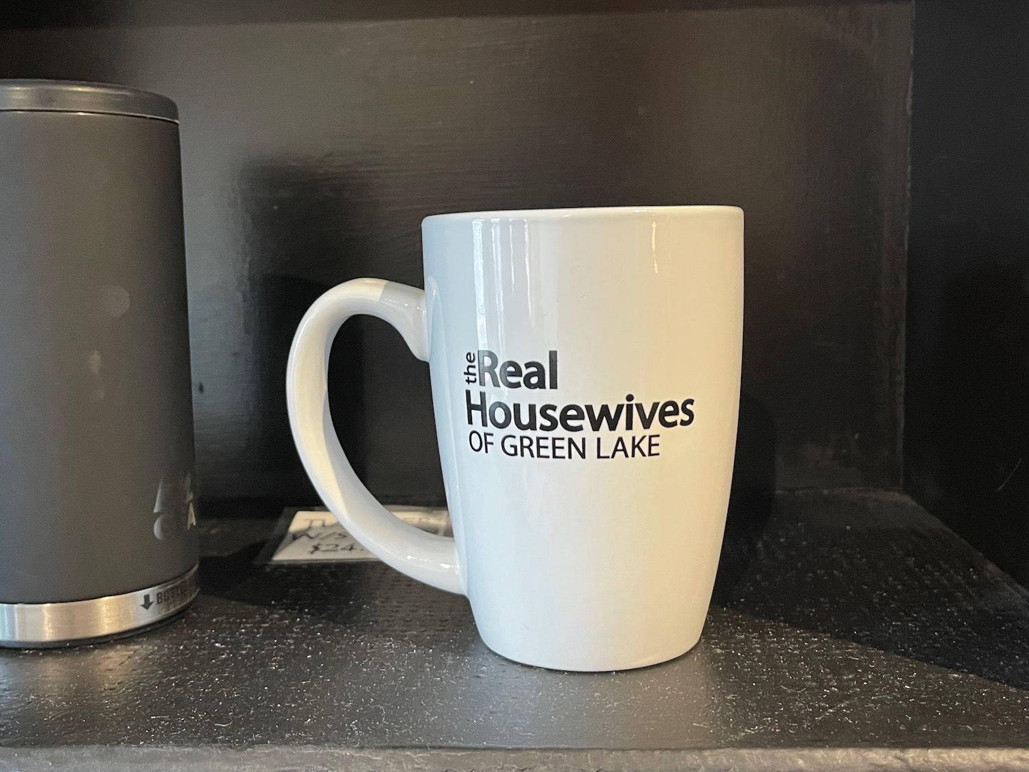 a white mug with black text on it