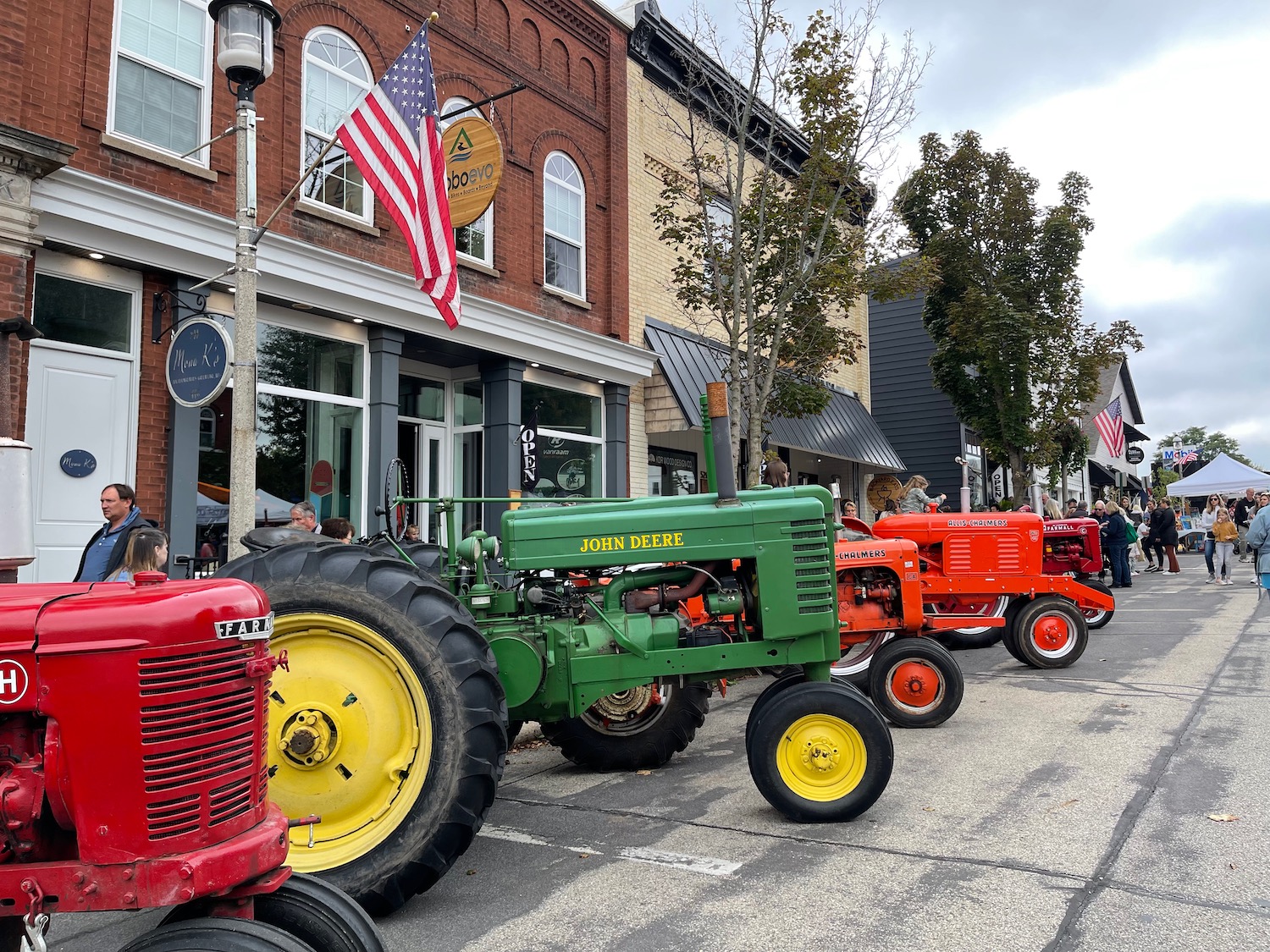 a row of tractors parked in front of a building