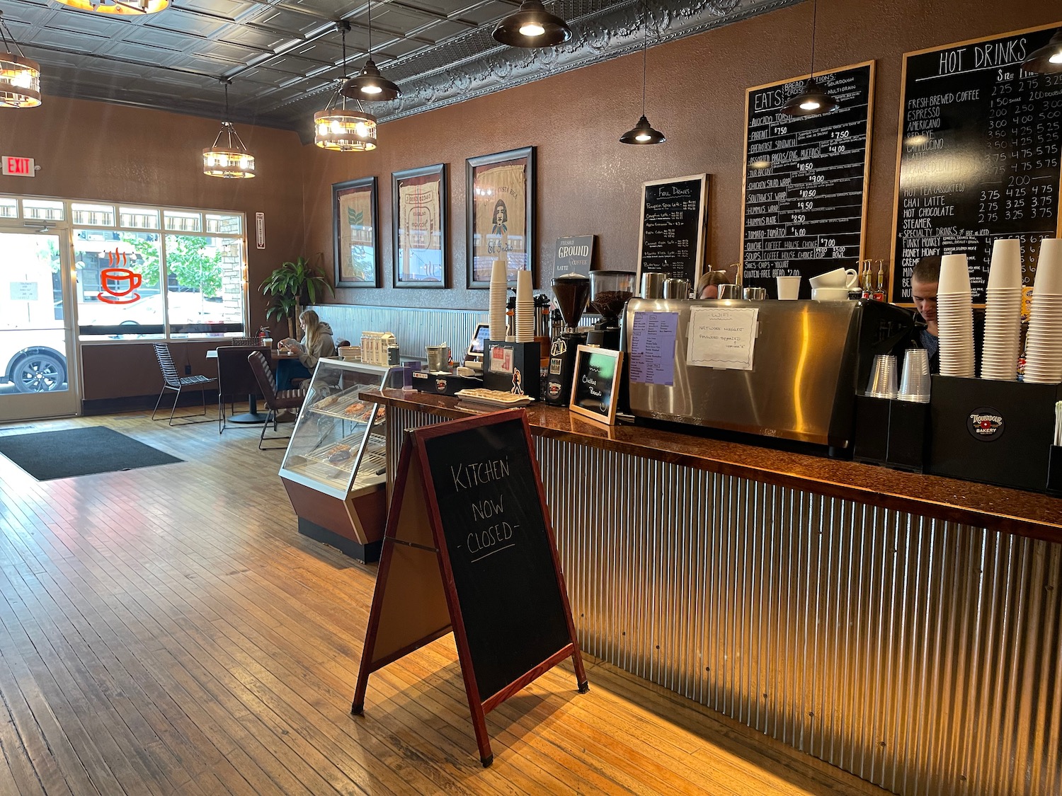 a coffee shop with a wood floor and a wood floor