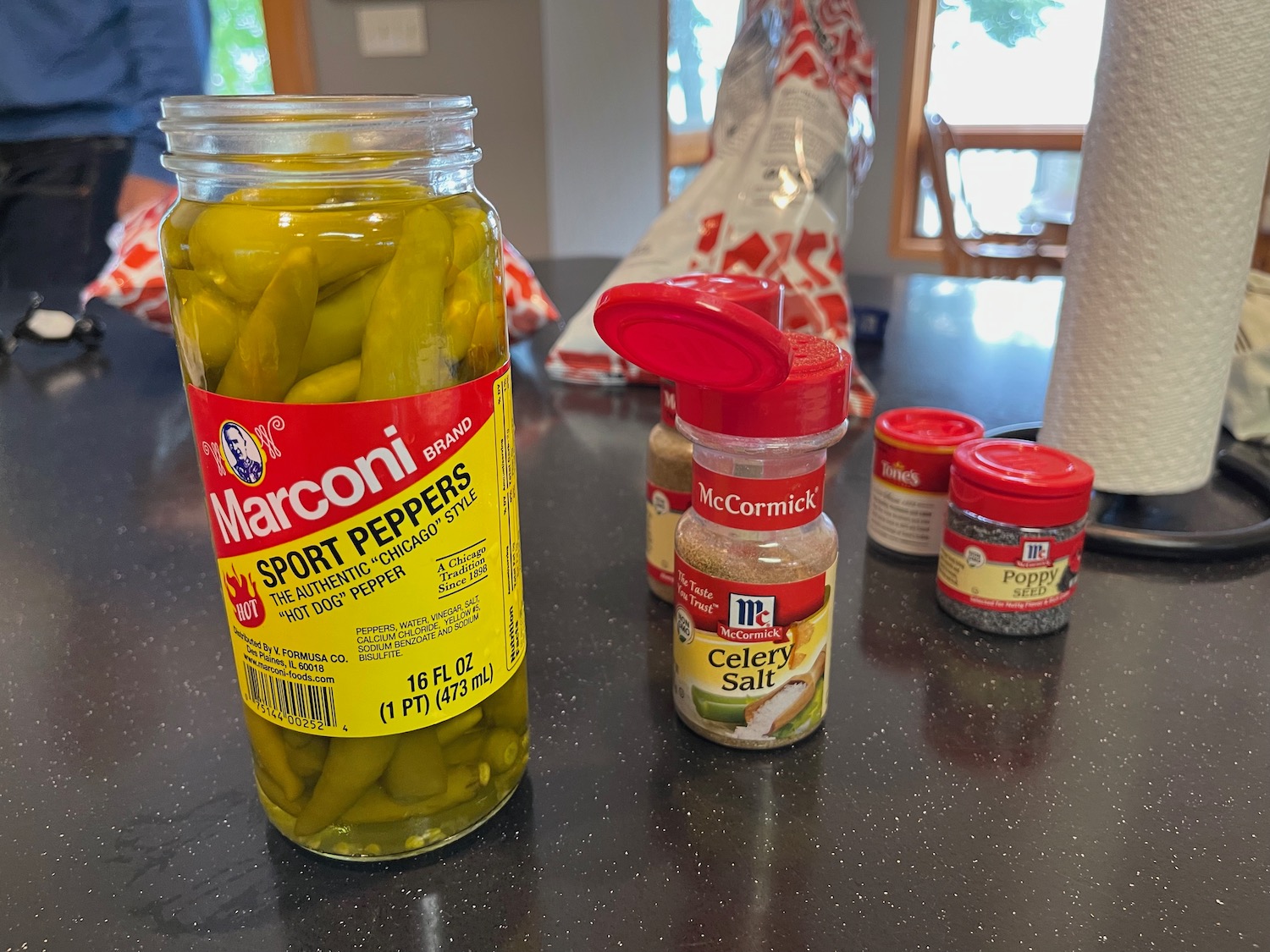 a jar of pickles and spices on a counter