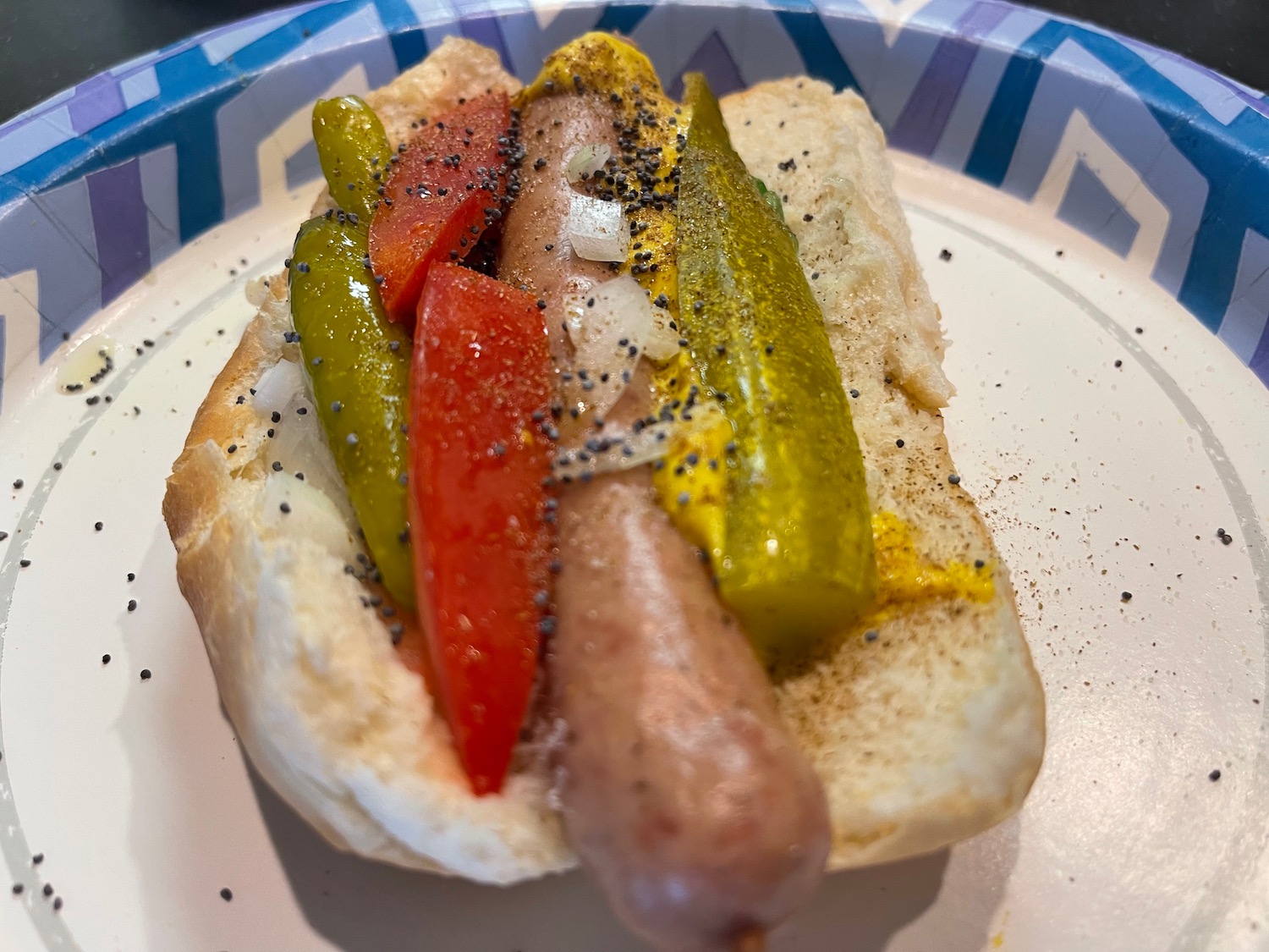 a hot dog with vegetables on a plate