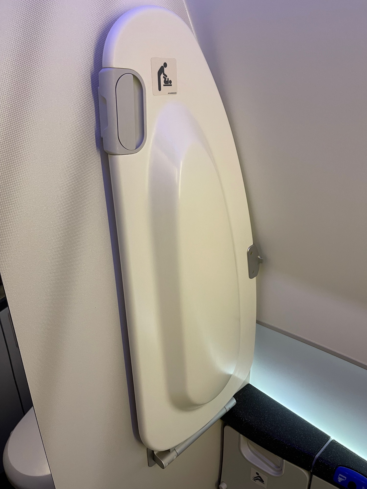 a white toilet seat on a plane