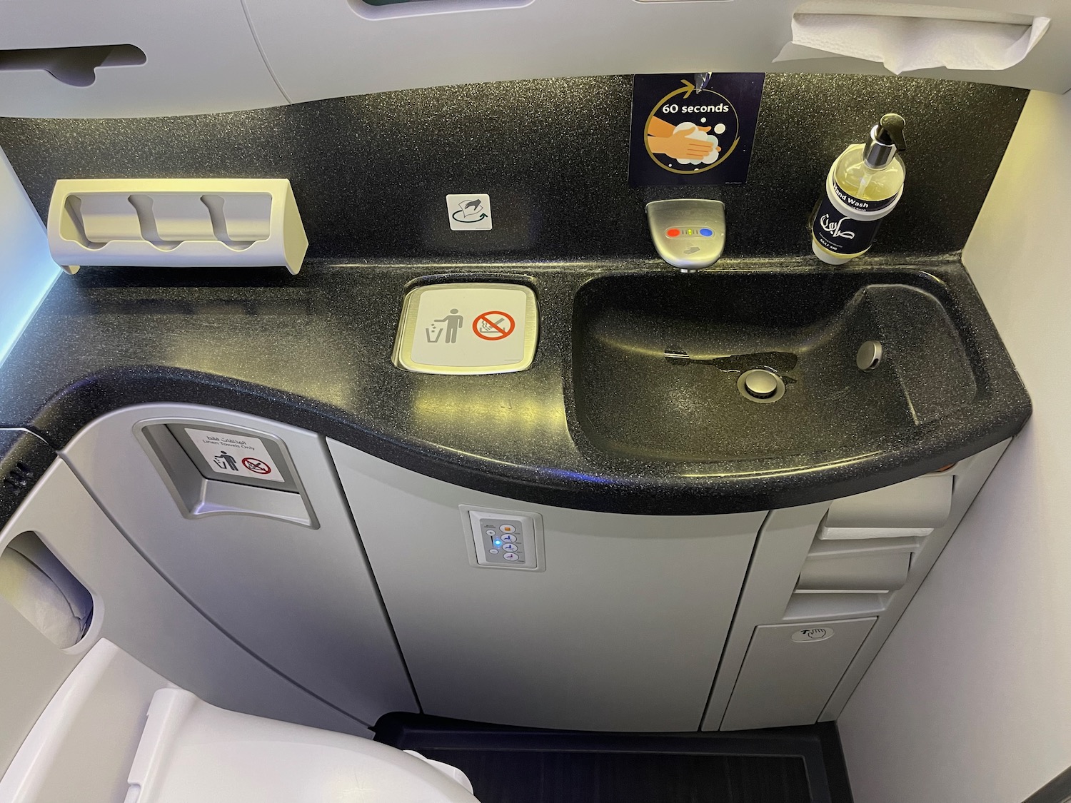 a sink and a seat in an airplane