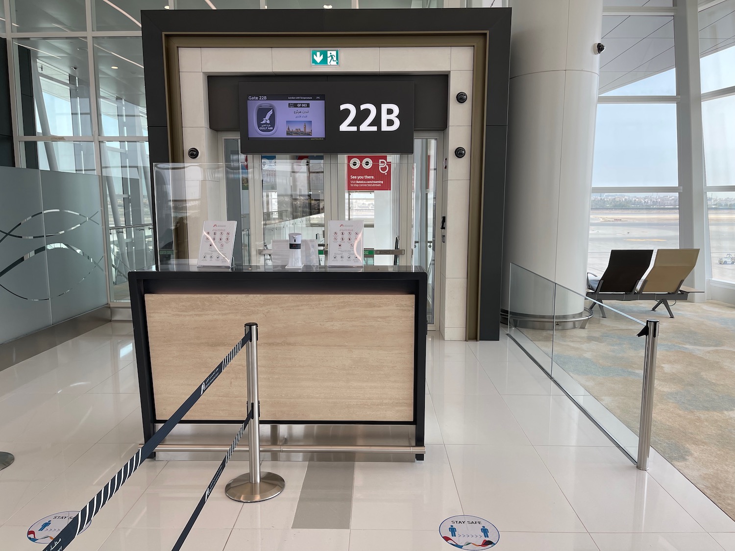 a glass door with a sign and a glass barrier