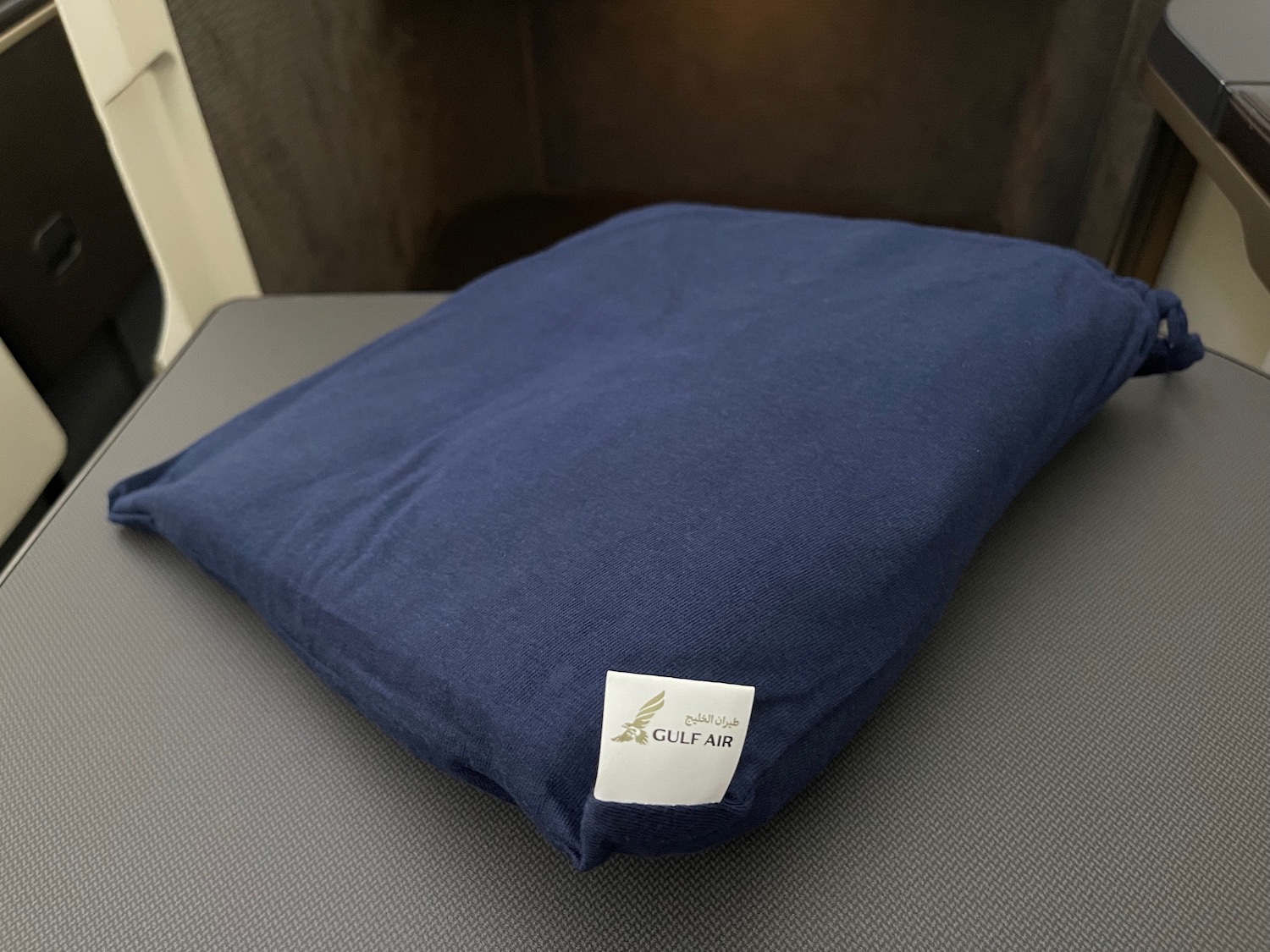 a blue pillow with a white label on it