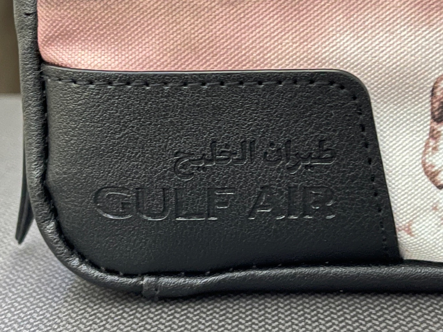 a black leather tag with writing on it