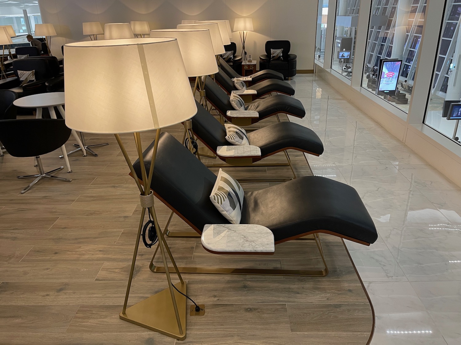 a row of chairs with lamps in a room