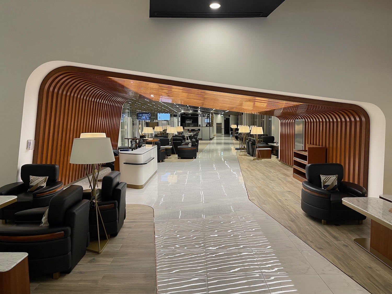 a lobby with a large mirror and chairs