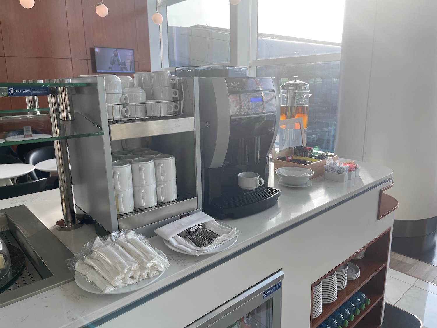 a coffee machine and cups on a counter