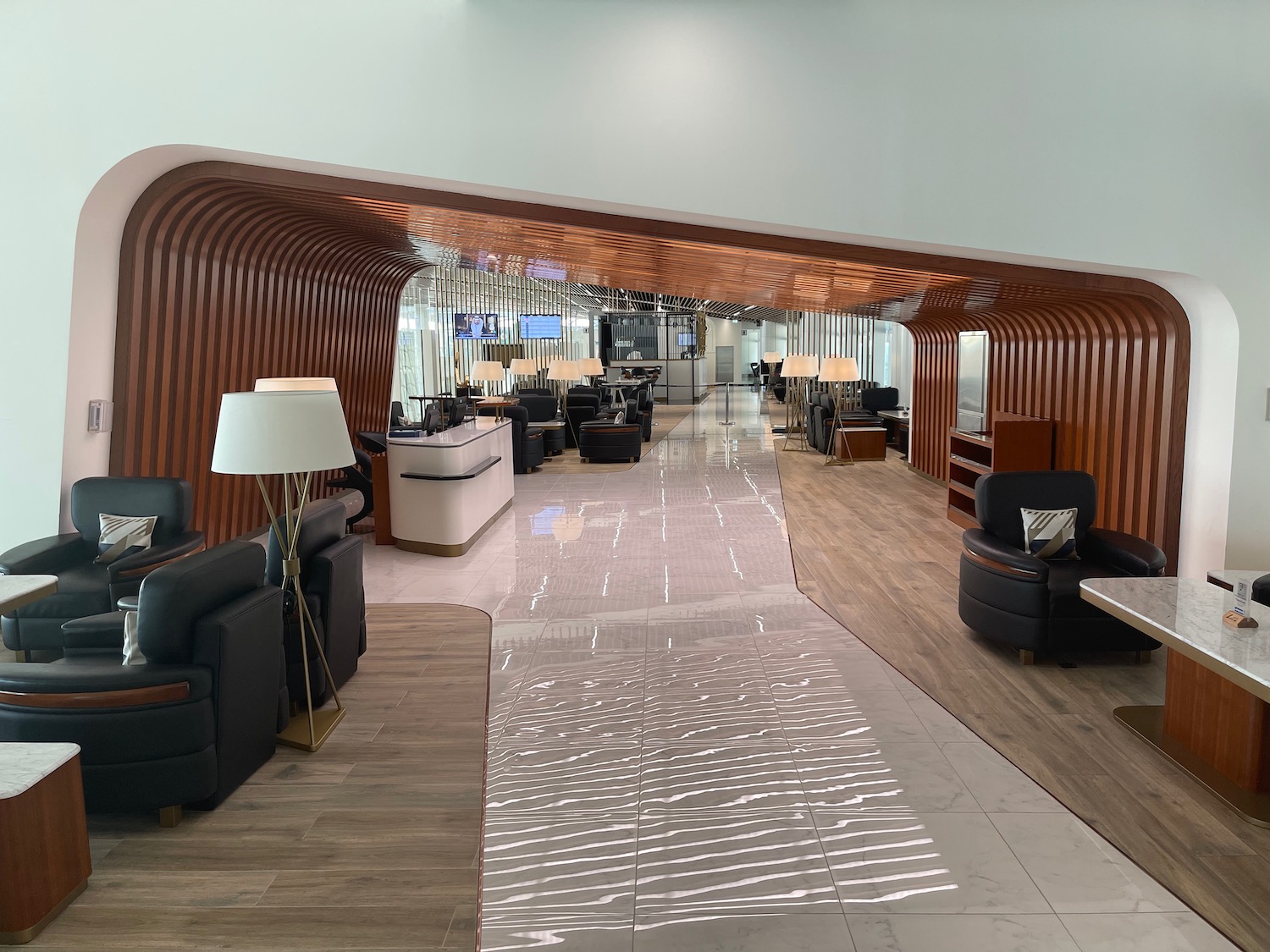 a lobby with a mirror and chairs