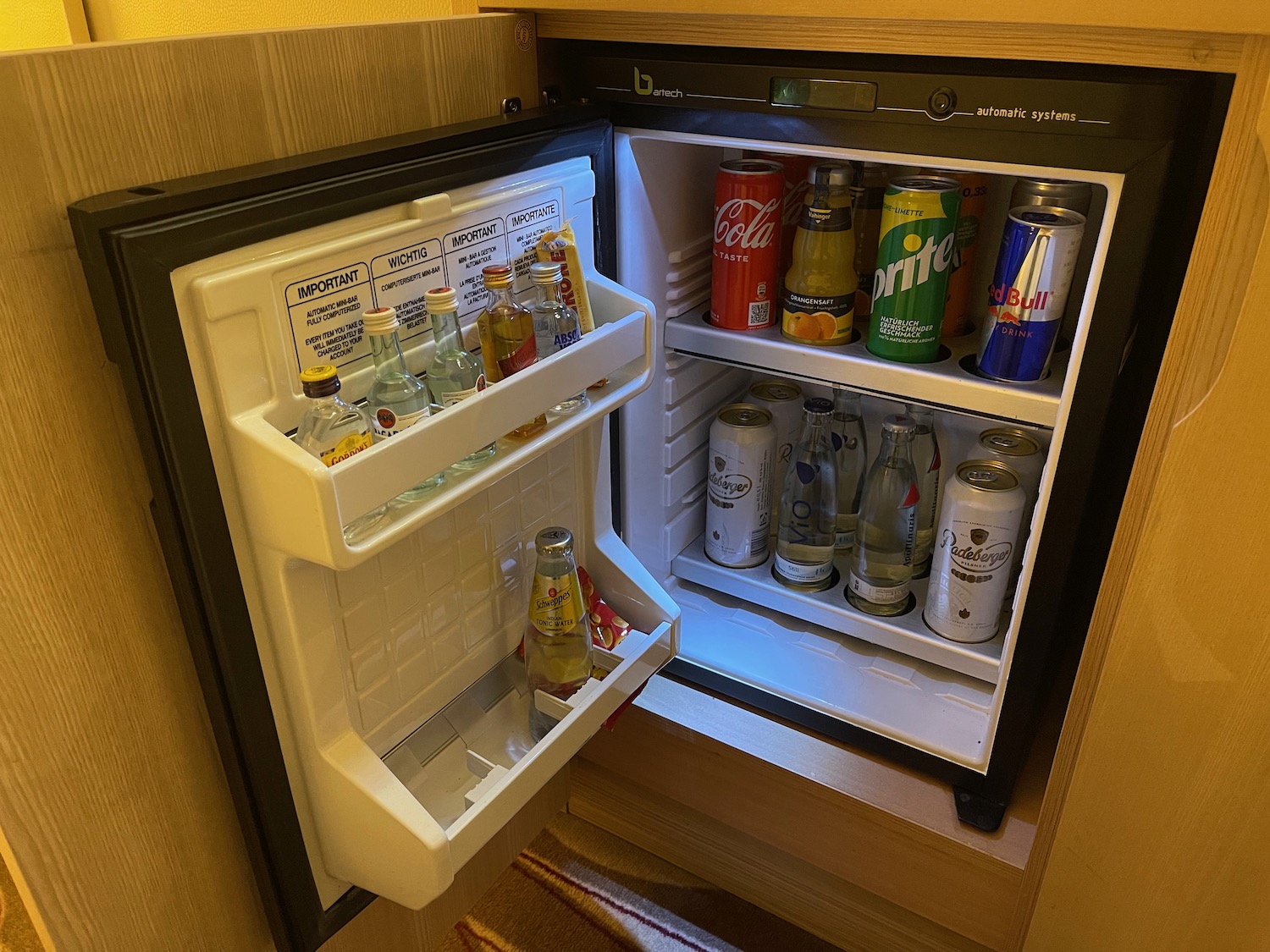 a mini fridge with drinks and cans