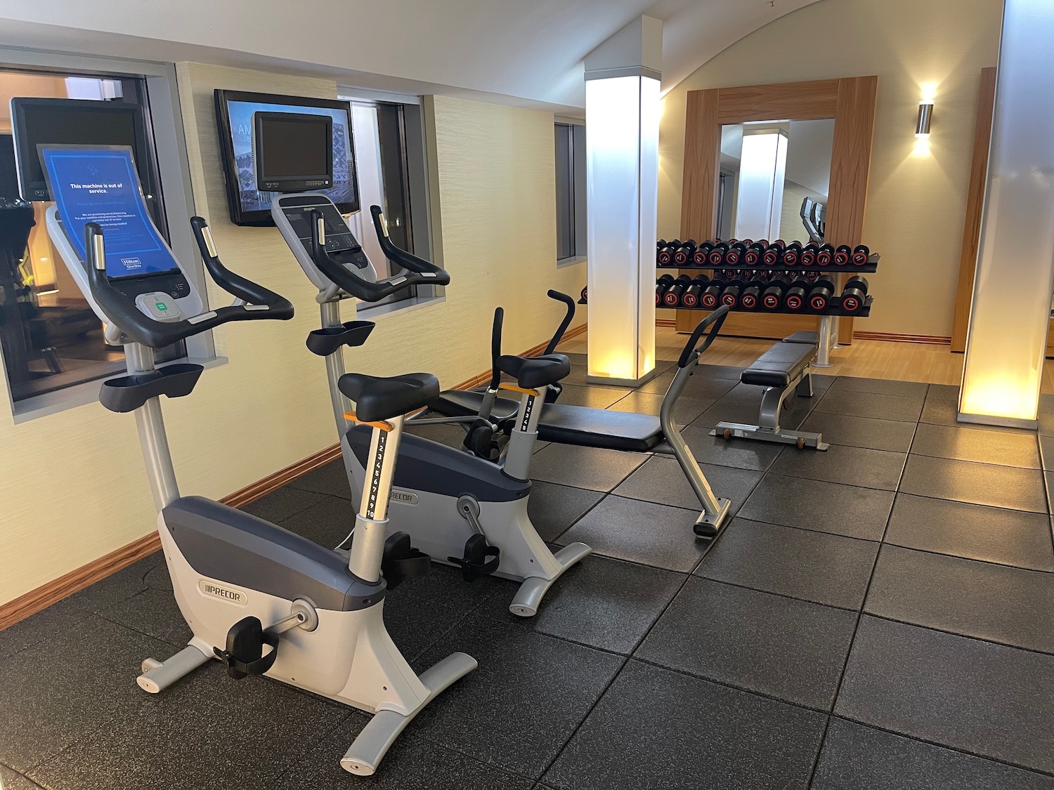 a gym with exercise bikes and a mirror