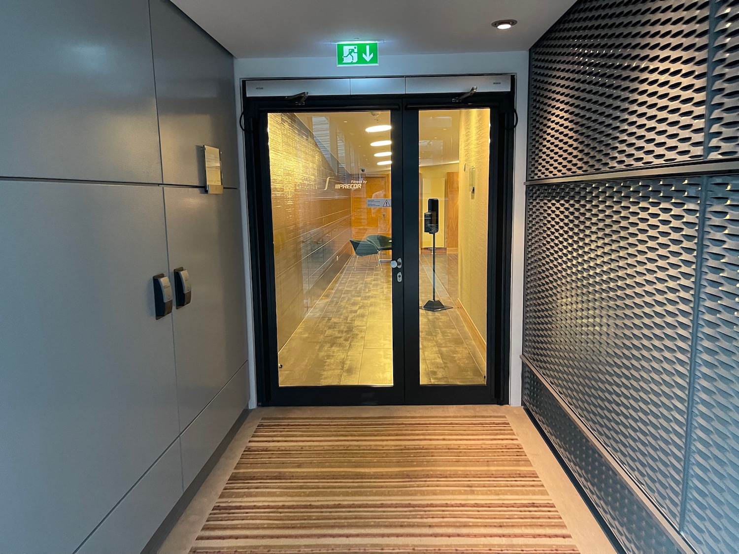 a glass door with a green sign