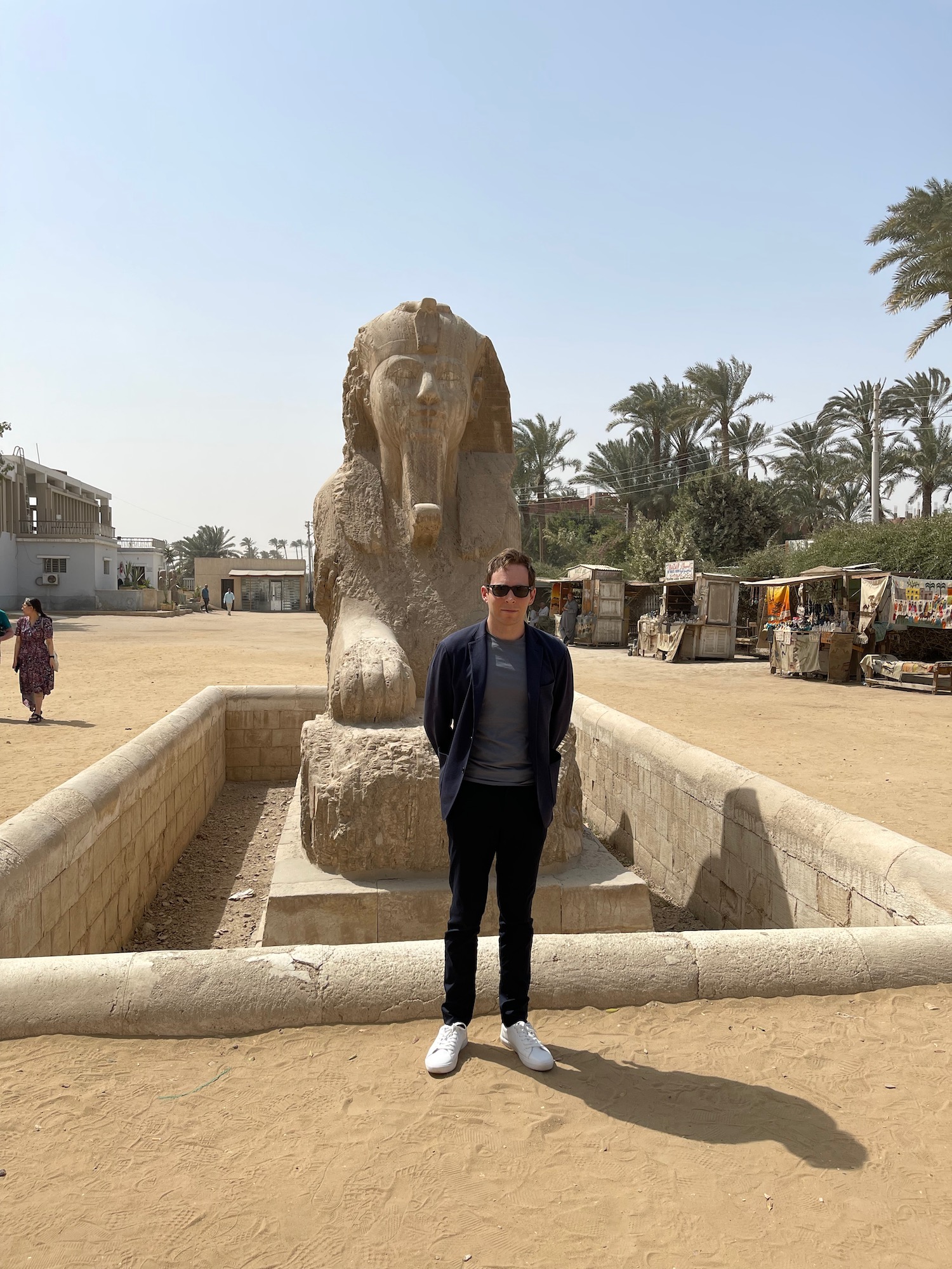 a man standing in front of a statue with Memphis in the background