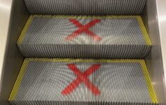 a escalator with red x signs