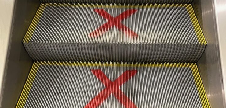 a escalator with red x signs