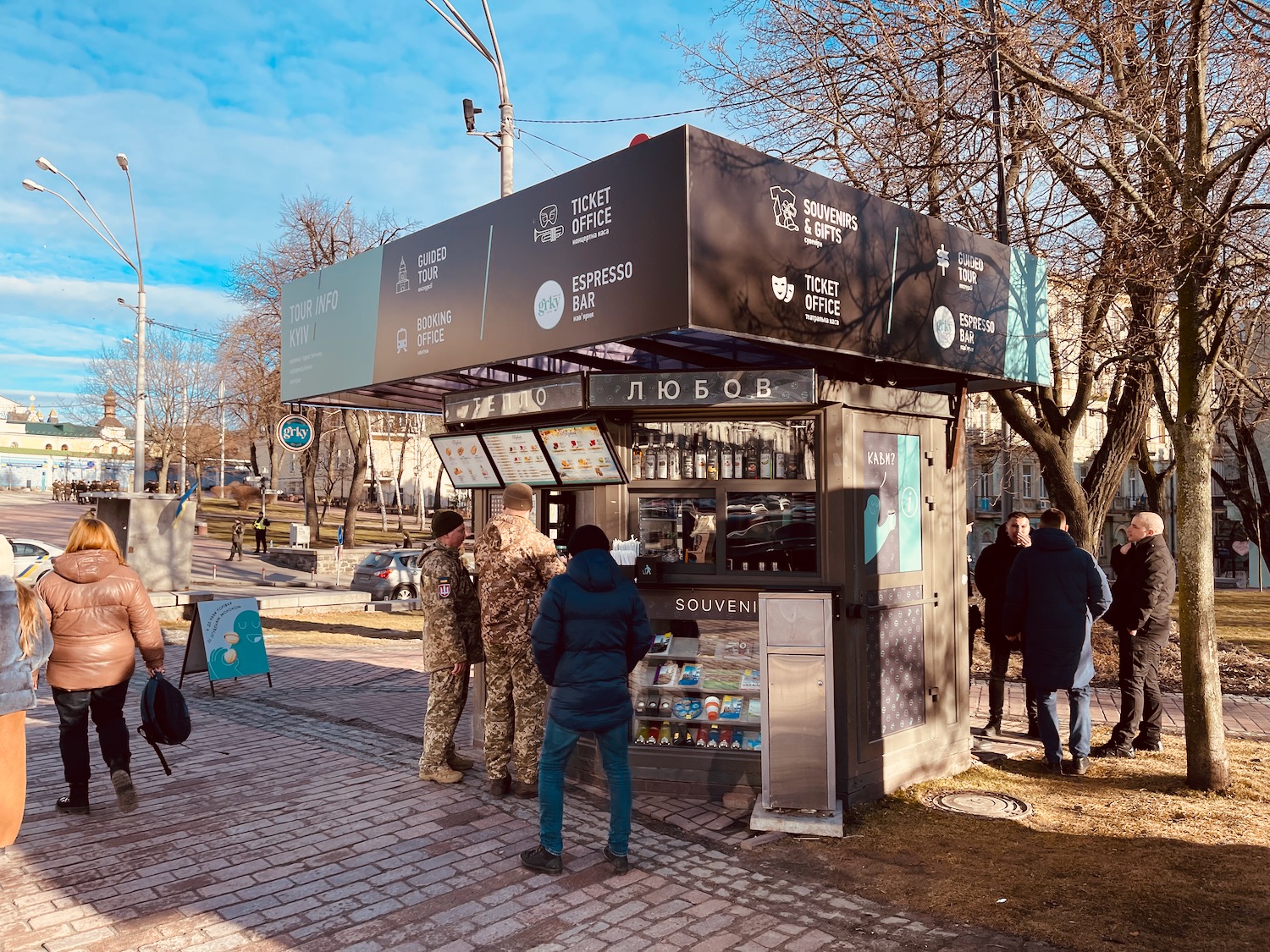 people standing in front of a food stand