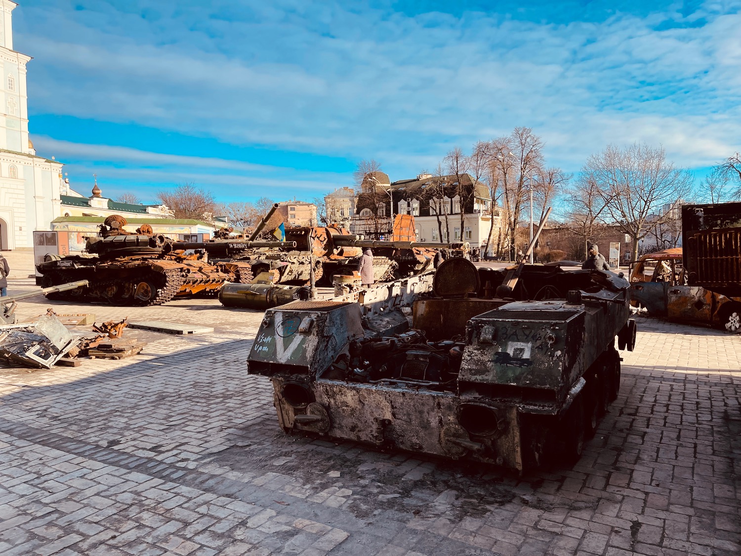 a group of military tanks on a brick road