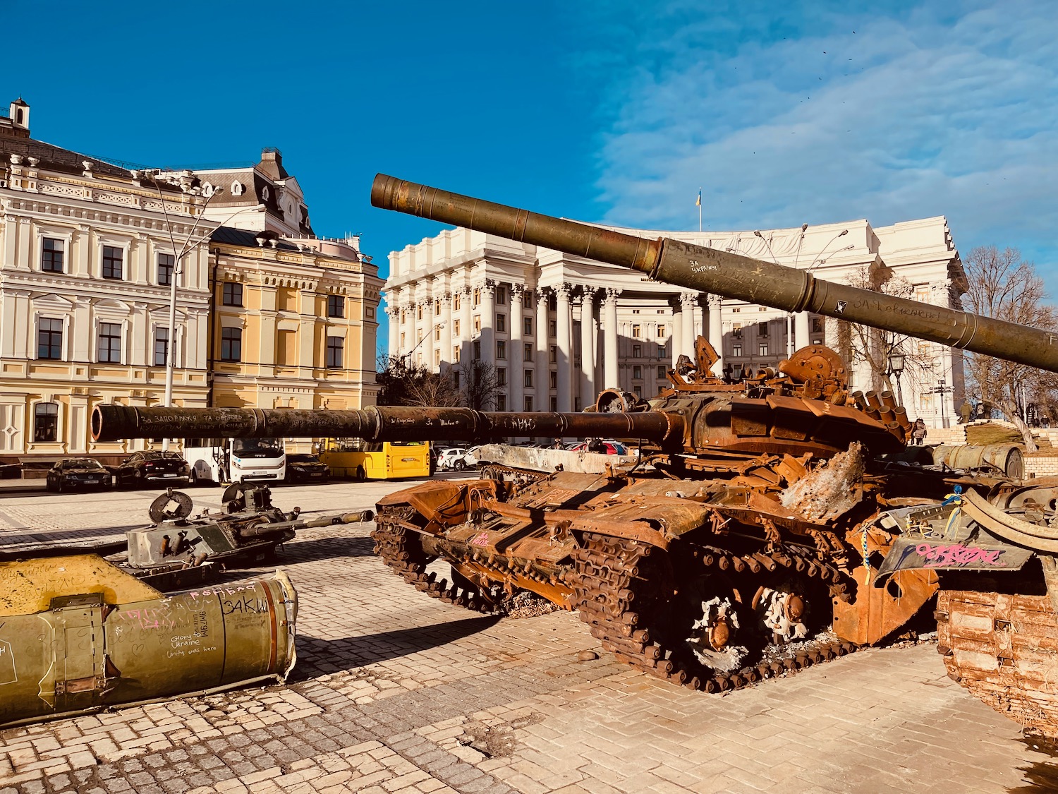 a tank with two large cannons in front of a building